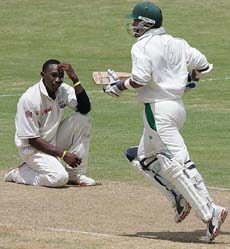 West Indies fast bowler Dwayne Bravo reacts while South Africa batsman Ashwell Prince add runs