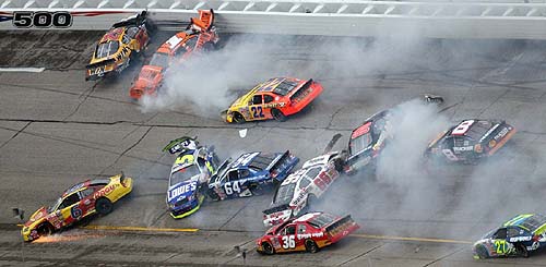 Eleven cars of a 15-car wreck spin through turn one during the rain delayed Aaron's 312 Busch Series race