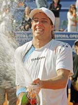 Argentina's Gaston Gaudio celebrates his victory over Spain's Tommy Robredo in the Estoril Open tennis tournament final in Estoril