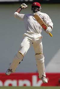 West Indies batsman Chris Gayle leaps into the air celebrating his triple century during the fourth day of the final Test against South Africa