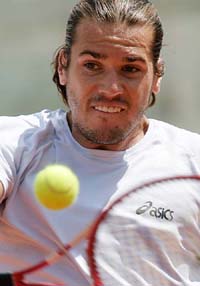 Germany's Tommy Hass returns the ball during his tennis match against Germany's Nikolas Kiefer in the first round of the Italian Masters tournament in Rome on Tuesday