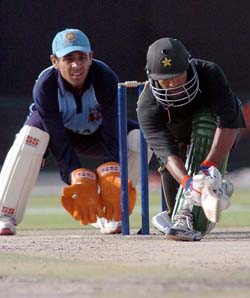 Yousuf Youhana of Pakistan Masters XI sweeps the ball to the leg as Indian wicket-keeper Manvinder Bisla looks on