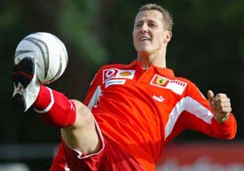 Ferrari's formula one driver Michael Schumacher controls the ball during a friendly soccer match
