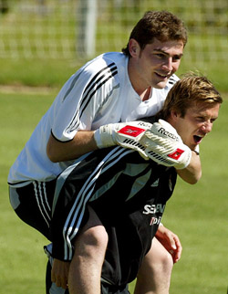 Real Madrid's David Beckham of England  carries team-mate goalkeeper Iker Casillas of Spain during their training session in Las Rozas