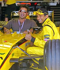Sachin Tendulkar with Narain Karthikeyan during a break at the Spanish Grand Prix practice session in Montmelo, near Barcelona, on Saturday