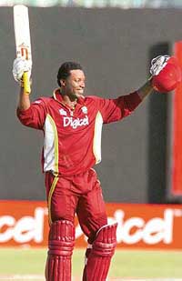 West Indies opening batsman Chris Gayle raises his bat after scoring a century against South Africa at Bridgetown, Barbados, on Wednesday.