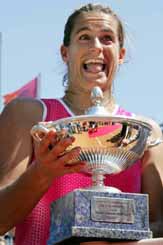 France's Amelie Mauresmo celebrates with her trophy after defeating Switzerland's Patty Schnyder
