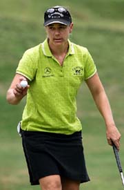 Annika Sorenstam of Sweden holds the ball after a birdie putt during the final round of the Chick-fil-A Charity Golf Championship in Stockbridge, Georgia, on Sunday. Annika won the title with a score of 23 under par.