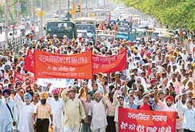 Activists of the Joint Platform of Mass Organisation hold a protest march and block traffic against the privatisation policy of the Punjab Government near the bus stand in Jalandhar on Friday.