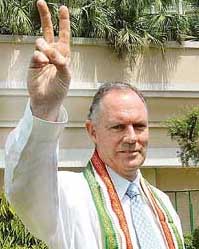 Former Australian captain and newly appointed Indian cricket coach Greg Chappell flashes the victory sign in New Delhi