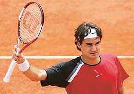 World number one Roger Federer of Switzerland waves to the crowd after an exhibition match against Thierry Ascione of France at the Roland Garros stadium in Paris on Sunday. The French Open tennis tournament starts on Monday