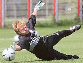 Goalkeeper Oliver Kahn of Bayern Munich dives for the ball during a training session in Munich on Wednesday. Bayern Munich will play Schalke 04 in the German soccer cup final in Berlin on Saturday.