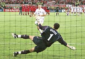 Polish goalkeeper Jerzy Dudek of Liverpool stops a penalty kick from Ukrainian forward Andriy Shevchenko of AC Milan during their Champions League final in Istanbul 