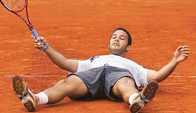 Argentina�s Jose Acasuso falls on the court after defeating Andy Roddick of the US 
