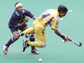Malaysia�s Azlan Misron (right) trips after being tackled by India�s Inderjeet Singh during a match at the 14th Sultan Azlan Shah Cup Hockey Tournament in Kuala Lumpur on Sunday.