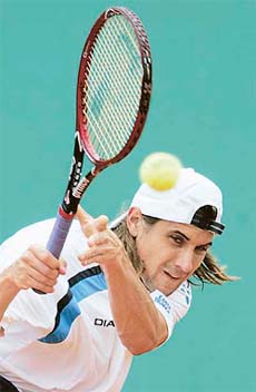 David Ferrer of Spain returns the ball to Gaston Gaudio of Argentina during their match in the fourth round of the French Open at Roland Garros