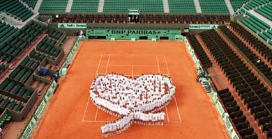 About 200 ball boys and girls form a heart on the central court