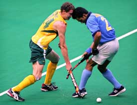 Australia�s Travis Brooks fights for the ball with India�s Jasvinder Singh during a match at the 14th Sultan Azlan Shah Cup Hockey Tournament in Kuala Lumpur on Friday