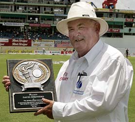 Umpire David Shepherd of England shows a plaque received from the Jamaica Cricket Board