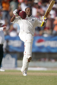 West Indies batsman Brian Lara celebrates after scoring a century on the second day of the second and final Test against Pakistan at Sabina Park in Kingston, Jamaica, on Saturday