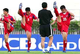 North Korea�s head coach Yun Jong-su watches players during a practice session ahead of the World Cup qualifying Asia Group B soccer match against Japan in Bangkok