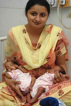 Gurpreet Kaur, mother of five-month premature twins, Luv and Kush, takes them in her lap at a hospital in Jalandhar on Tuesday. The babies weighed 540 and 610 gm, respectively, at the time of birth, but are now out of danger.