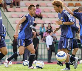 Japan soccer team members Hidetoshi Nakata and Masashi Oguro dribble during a practice session before their World Cup qualifying match against North Korea in Bangkok