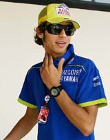 Italian Moto GP Yamaha rider Valentino Rossi, who leads the points race, smiles before a press conference at the Circuit de Catalunya race track in Spain on Thursday