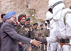 Prime Minister Manmohan Singh along with Army Chief Gen J.J. Singh shakes hands with Army jawans during his visit to base camp in Siachen on Sunday.