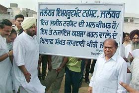 The Chairman of the Improvement Trust, Mr Tejinder Singh Bittu, and the Minister of Local Bodies, Choudhry Jagjit Singh, are jubilant after the trust reclaims its land which had been occupied illegally by a baba in Jalandhar