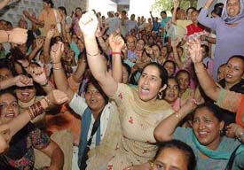 Members of the Anganwari Mulazam Union, Punjab, stage a protest dharna outside the Deputy Commissioner’s office in Jalandhar on Monday.