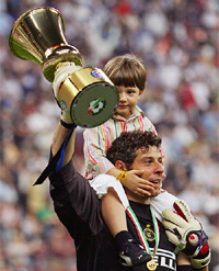 Inter Milan goalkeeper Francesco Toldo raises the Italian Cup trophy as he carries his son Alessandro on his shoulders after their victory over AS Roma in Milan on Wednesday
