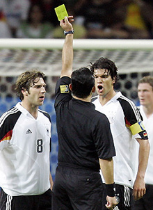 German captain Michael Ballack receives a yellow card from referee Carlos Amarilla during their Confederations Cup match against Australia in Frankfurt on Wednesday
