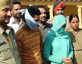 Ashish and Reena in police custody after they were nabbed in connection with the murder of their landlady in Jalandhar on Saturday.