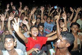 Bangladeshi youths celebrate the victory of their cricket team in Dhaka on Sunday
