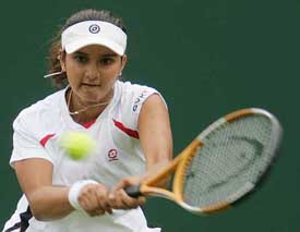 Sania Mirza hits a backhand return to Akiko Morigami of Japan during their first round match at Wimbledon on Monday