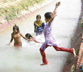 Young girls beat the heat in a canal in Samana