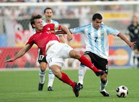 Germany�s Bernd Schneider challenges Argentina�s Carlos Tevez during their Confederations Cup Group A soccer match in Nuremberg