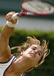 Amelie Mauresmo of France serves to Shenay Perry of the USA in a third round match at Wimbledon on Friday. Mauresmo won 6-0, 6-2.