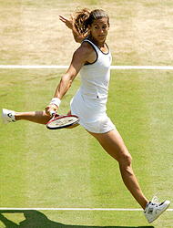 Amelie Mauresmo of France returns the ball to Anastasia Myskina of Russia in their quarterfinal match at Wimbledon on Tuesday