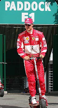 Ferrari�s Formula One driver Michael Schumacher of Germany arrives for the first free practice session of the French Grand Prix at the Magny Cours circuit on Friday. The race will take place on Sunday