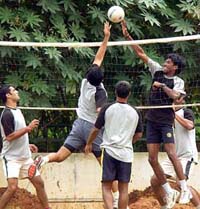 Indian pace bowlers, including Laxmipathy Balaji, play volleyball on the seventh day of the fitness camp at the National Cricket Academy in Bangalore on Sunday