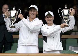 Zimbabwe�s Cara Black and South Africa�s Liezel Huber hold the winners� trophies after their women�s doubles final against Russia�s Svetlana Kuznetsova and France�s Amelie Mauresmo at Wimbledon in London on Sunday
