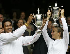India�s Mahesh Bhupathi and Mary Pierce of France hold the mixed doubles winners� trophies at Wimbledon