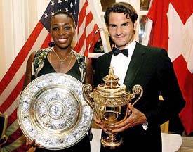 Wimbledon champions Venus Williams  of the USA and Roger Federer of Switzerland hold their trophies at the champions dinner in London on Sunday
