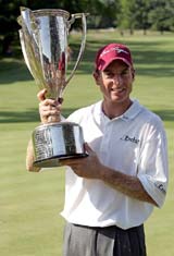 Jim Furyk holds the trophy after winning the Western Open in Lemont, Illinois, on Sunday. Furyk shot a two-under 69 for a two-stroke victory over Tiger Woods