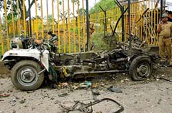 A securityman stands guard near the wreckage of the jeep used by terrorists in Ayodhya on Tuesday.