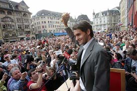 Wimbledon champion Roger Federer waves to the crowd during a welcome ceremony at his hometown Basle in Switzerland on Monday