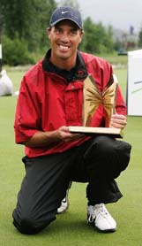 Canadian golfer Stephen Ames holds the Telus Skins Game Trophy after emerging victorious in Whistler, British Columbia, on Tuesday