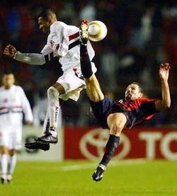 Silveira Cocito of Atletico Paranaense performs a scissors-kick next to Marcio Amoroso of Sao Paulo FC during their Libertadores Cup first leg final soccer match